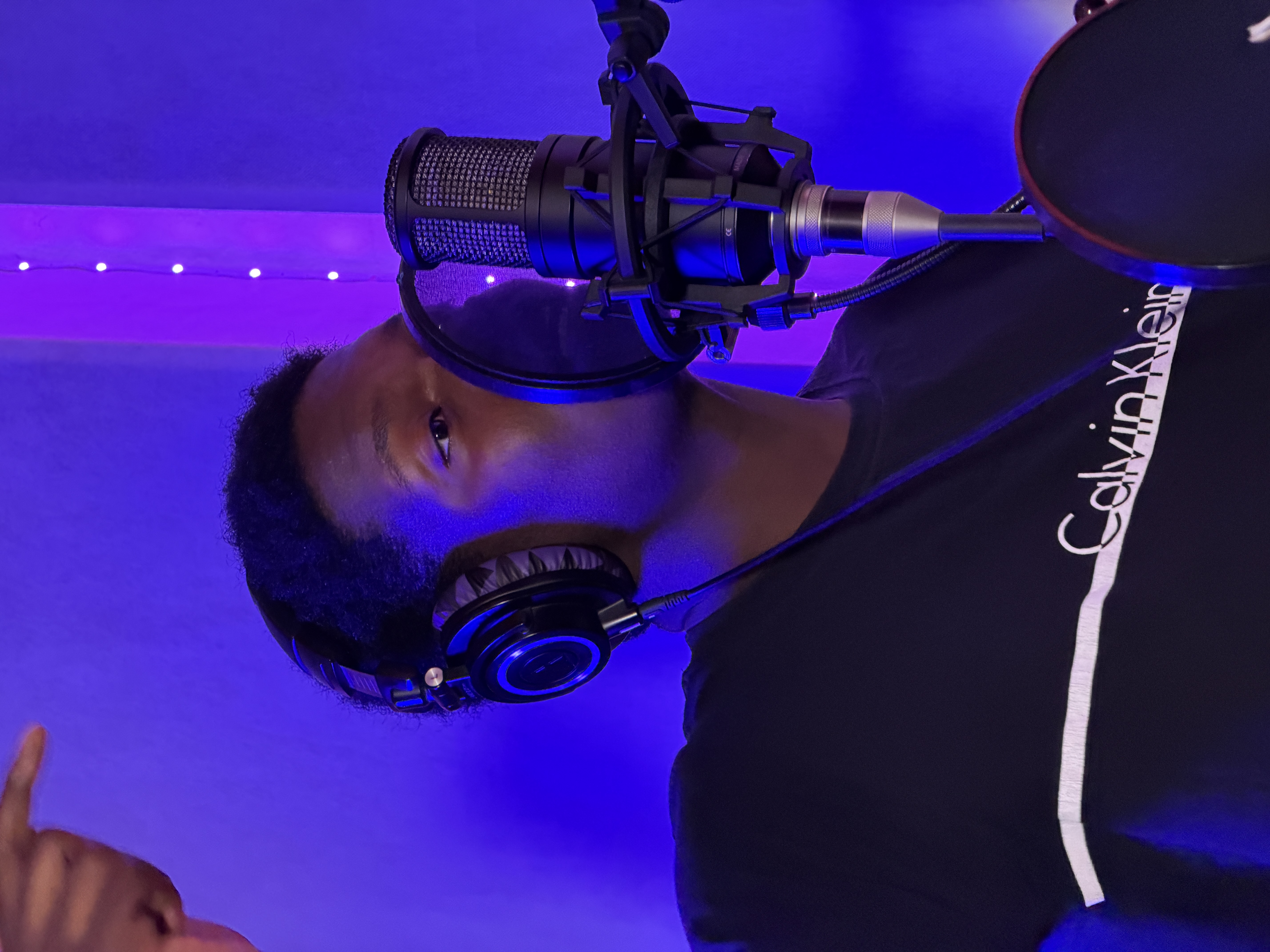 The Artist sings into a microphone Neumann M149